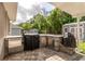 Outdoor kitchen featuring grill, stainless steel appliances, sink and bar area at 5026 Sw 128Th St, Ocala, FL 34473