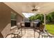 Covered outdoor kitchen includes built-in grill, bar, and seating area at 5026 Sw 128Th St, Ocala, FL 34473