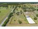 Aerial view of the property highlighting the surrounding pastures, fenced boundaries and road access at 5363 Nw 153Rd Ct, Morriston, FL 32668
