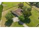 Aerial view of home with mature trees, driveway and well maintained lawn at 5363 Nw 153Rd Ct, Morriston, FL 32668