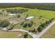 Aerial view showcases large property featuring riding arena, fenced pastures, and mature landscaping at 5363 Nw 153Rd Ct, Morriston, FL 32668