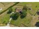 Aerial view of home featuring driveway, mature trees, and fenced yard at 5363 Nw 153Rd Ct, Morriston, FL 32668
