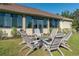 Relaxing outdoor seating area with a round fire pit and Adirondack chairs at 5363 Nw 153Rd Ct, Morriston, FL 32668