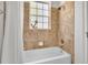 Bathroom featuring a tub with shower and a window at 5363 Nw 153Rd Ct, Morriston, FL 32668