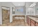 The beautiful bathroom features a walk-in shower, a garden tub, double sinks, and tile flooring at 5363 Nw 153Rd Ct, Morriston, FL 32668