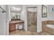 Bathroom boasts granite counters, a glass shower, and a soaking tub, perfect for relaxation at 5363 Nw 153Rd Ct, Morriston, FL 32668
