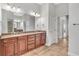 Bathroom featuring dual sinks with granite counters and dark wood cabinets at 5363 Nw 153Rd Ct, Morriston, FL 32668