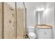 Bathroom features a glass shower, toilet, sink, and vanity with neutral tones and modern fixtures at 5363 Nw 153Rd Ct, Morriston, FL 32668