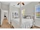 Bright bedroom with a four poster bed, hardwood floors, and ceiling fan at 5363 Nw 153Rd Ct, Morriston, FL 32668