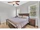 Bedroom features a large bed, two windows, and two nightstands at 5363 Nw 153Rd Ct, Morriston, FL 32668