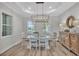 Formal dining room with modern chandelier and views of the surrounding landscape at 5363 Nw 153Rd Ct, Morriston, FL 32668