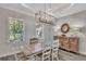 Bright dining room features a wooden table, accent lighting, and matching buffet at 5363 Nw 153Rd Ct, Morriston, FL 32668