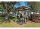 Home with a partially covered porch, mature trees and shrubs at 5363 Nw 153Rd Ct, Morriston, FL 32668