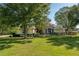 Well-manicured lawn, mature trees, and sprinkler system enhancing the curb appeal of this charming home at 5363 Nw 153Rd Ct, Morriston, FL 32668