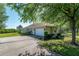 Charming home with a two-car garage, manicured lawn, and mature shade trees at 5363 Nw 153Rd Ct, Morriston, FL 32668