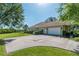 Lovely single-story house featuring an attached two-car garage, lush lawn and mature landscaping at 5363 Nw 153Rd Ct, Morriston, FL 32668
