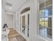 Bright foyer with french doors, hardwood floors, and large window showcasing the outdoor view at 5363 Nw 153Rd Ct, Morriston, FL 32668