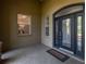 Covered front porch with a window, double doors, and tiled floor, offering a welcoming entrance at 5363 Nw 153Rd Ct, Morriston, FL 32668
