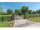Property entrance gate with stone pillars and address number at 5363 Nw 153Rd Ct, Morriston, FL 32668