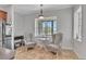 Kitchen nook with two paisley chairs, table, and large windows at 5363 Nw 153Rd Ct, Morriston, FL 32668