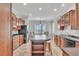Traditional kitchen with wooden cabinets, kitchen island, and modern appliances at 5363 Nw 153Rd Ct, Morriston, FL 32668