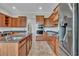 Modern kitchen with built in oven, stainless steel fridge, island with sink, and ample cabinetry at 5363 Nw 153Rd Ct, Morriston, FL 32668
