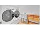 Laundry room features a Whirlpool washer and dryer, utility sink, and wooden cabinet at 5363 Nw 153Rd Ct, Morriston, FL 32668