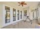 Sunroom features tiled floor, a ceiling fan and lots of natural light and french door access at 5363 Nw 153Rd Ct, Morriston, FL 32668