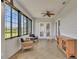 Relaxing sunroom featuring tiled floor, a ceiling fan and lots of natural light and comfortable furnishings at 5363 Nw 153Rd Ct, Morriston, FL 32668