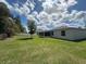 Backyard with white fencing and enclosed back porch at 593 Marion Oaks Trl, Ocala, FL 34473
