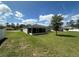Expansive backyard featuring a screened-in patio and well-maintained lawn, perfect for outdoor relaxation and entertaining at 593 Marion Oaks Trl, Ocala, FL 34473