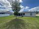Spacious backyard features healthy grass, white fence, and views of the home at 593 Marion Oaks Trl, Ocala, FL 34473