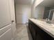 Bathroom features double sink vanity with a large mirror, tiled floor and a glass door shower at 593 Marion Oaks Trl, Ocala, FL 34473