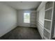 Carpeted bedroom with built-in shelving and natural light from a large window at 593 Marion Oaks Trl, Ocala, FL 34473