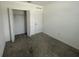 Bedroom with neutral carpet, closet and a door to the hallway at 593 Marion Oaks Trl, Ocala, FL 34473