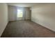 Spacious bedroom with neutral walls, carpet flooring, and large window with natural light at 593 Marion Oaks Trl, Ocala, FL 34473