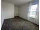 Carpeted bedroom featuring a large window with neutral walls at 593 Marion Oaks Trl, Ocala, FL 34473
