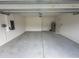 Spacious garage with a concrete floor and water heater at 593 Marion Oaks Trl, Ocala, FL 34473