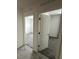 Hallway leading to a bedroom with neutral carpet and light walls at 593 Marion Oaks Trl, Ocala, FL 34473