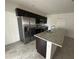 Modern open kitchen featuring stainless steel appliances, granite countertops, and a large island at 593 Marion Oaks Trl, Ocala, FL 34473
