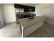 Spacious kitchen island with granite countertop, stainless steel sink, and modern fixtures at 593 Marion Oaks Trl, Ocala, FL 34473