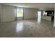Bright living room with tile floors, large windows and an open floor plan connected to the kitchen at 593 Marion Oaks Trl, Ocala, FL 34473
