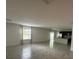 Bright and open living room with tile floors, large windows, and access to the kitchen at 593 Marion Oaks Trl, Ocala, FL 34473