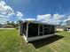 View of the screened-in patio overlooking the backyard, offering a comfortable and insect-free outdoor living space at 593 Marion Oaks Trl, Ocala, FL 34473
