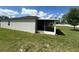 Side view of the screened patio and stucco wall and backyard, highlighting the privacy and seamless design of the outdoor space at 593 Marion Oaks Trl, Ocala, FL 34473