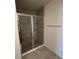 Modern shower stall with glass doors, tiled walls, and neutral floor tile at 593 Marion Oaks Trl, Ocala, FL 34473