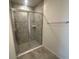 Modern shower stall with glass doors, tiled walls, and neutral floor tile at 593 Marion Oaks Trl, Ocala, FL 34473