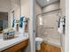 Bathroom featuring a glass-enclosed shower, wood-look flooring, and wooden vanity at 710 Antonia Ln, The Villages, FL 32159