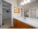 Bright bathroom featuring a white countertop, wood cabinets, and a spacious walk-in closet at 710 Antonia Ln, The Villages, FL 32159