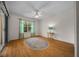 Bedroom featuring a ceiling fan, window, and stylish wood-look flooring at 710 Antonia Ln, The Villages, FL 32159